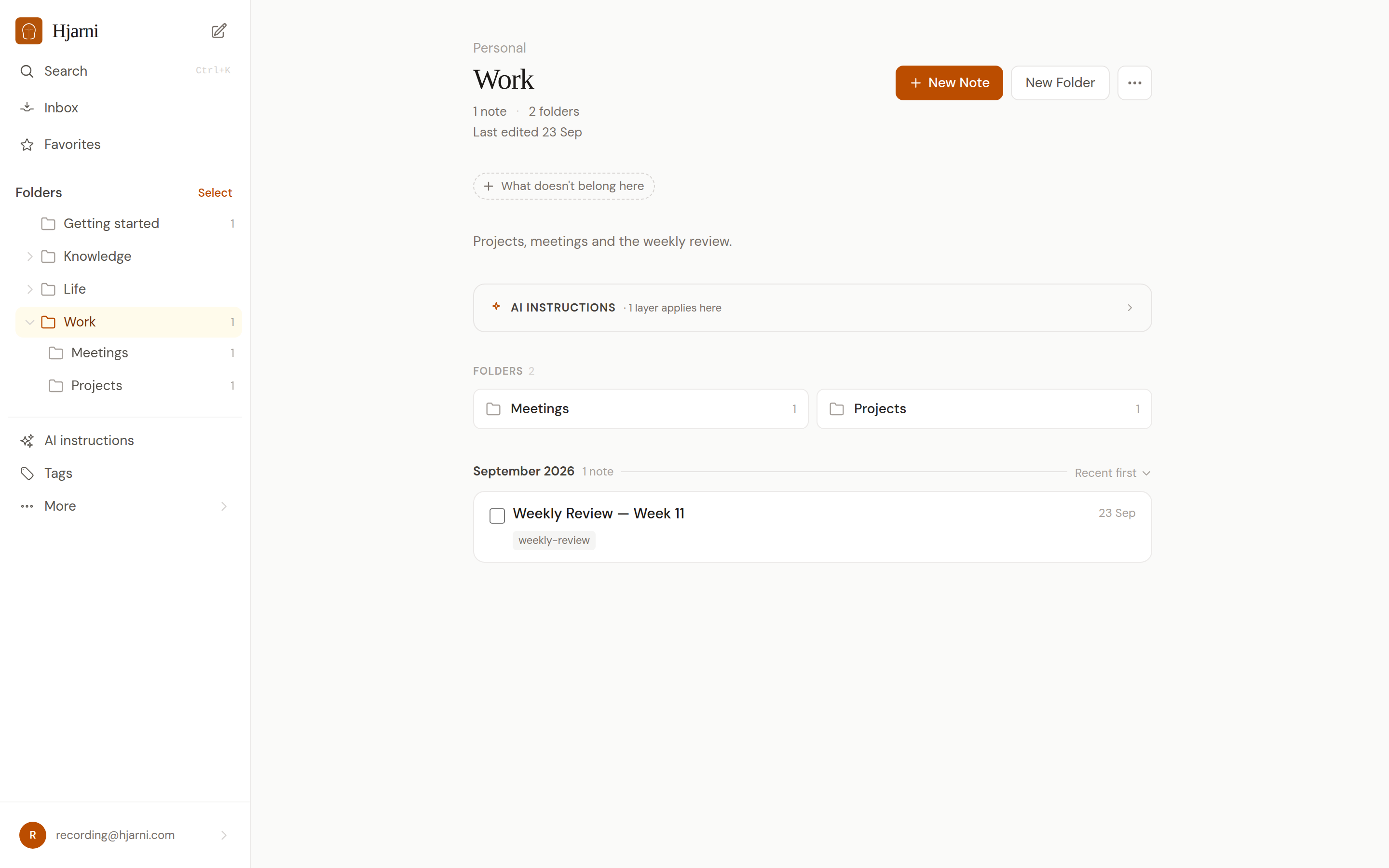 The Work folder open in Hjarni, with its description, an AI instructions panel, two sub-folders (Meetings and Projects) and one tagged note.